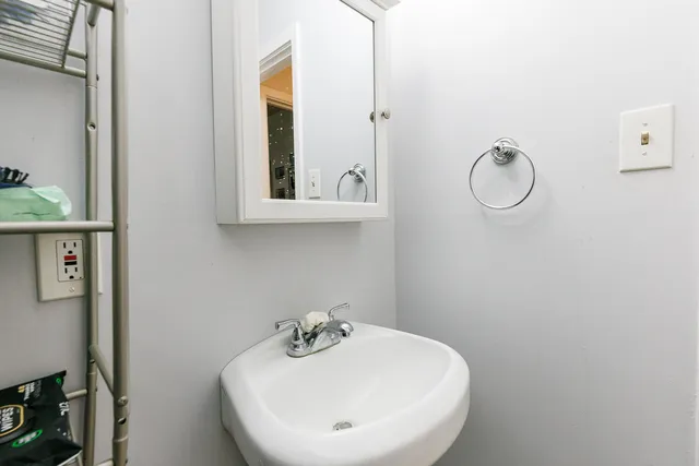 a bathroom with a sink and mirror