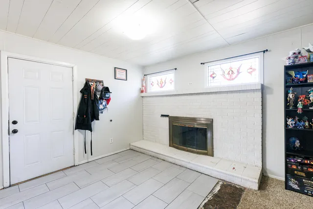 a view of livingroom with furniture and a fireplace