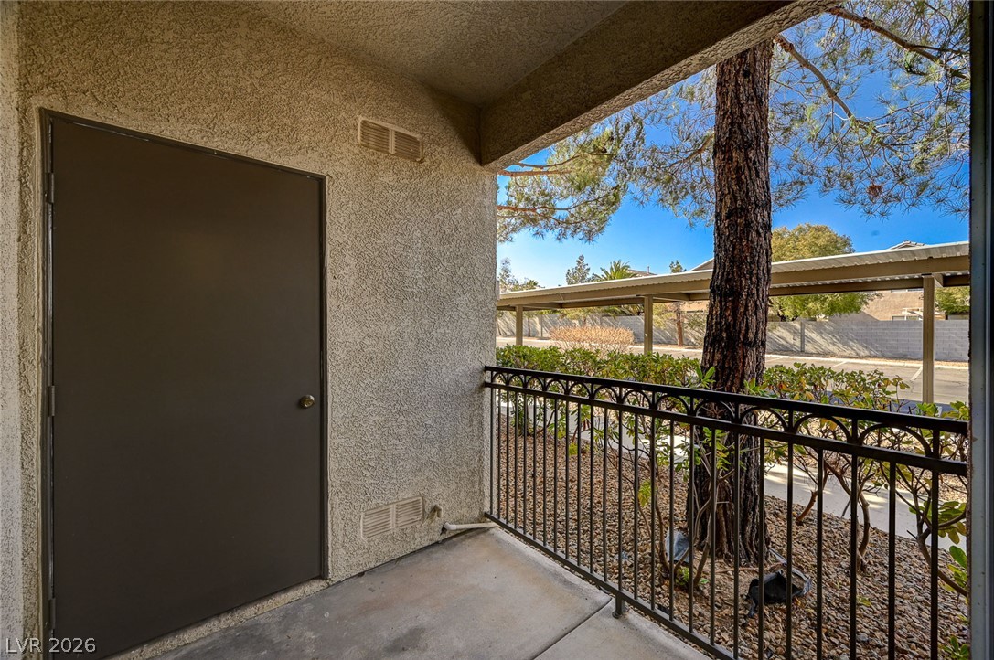 9050 West Warm Springs Road, Unit 1147 Las Vegas, NV 89148 - Photo 18 of 36 An inviting private patio offers a pleasant outdoor retreat with a view of mature trees.