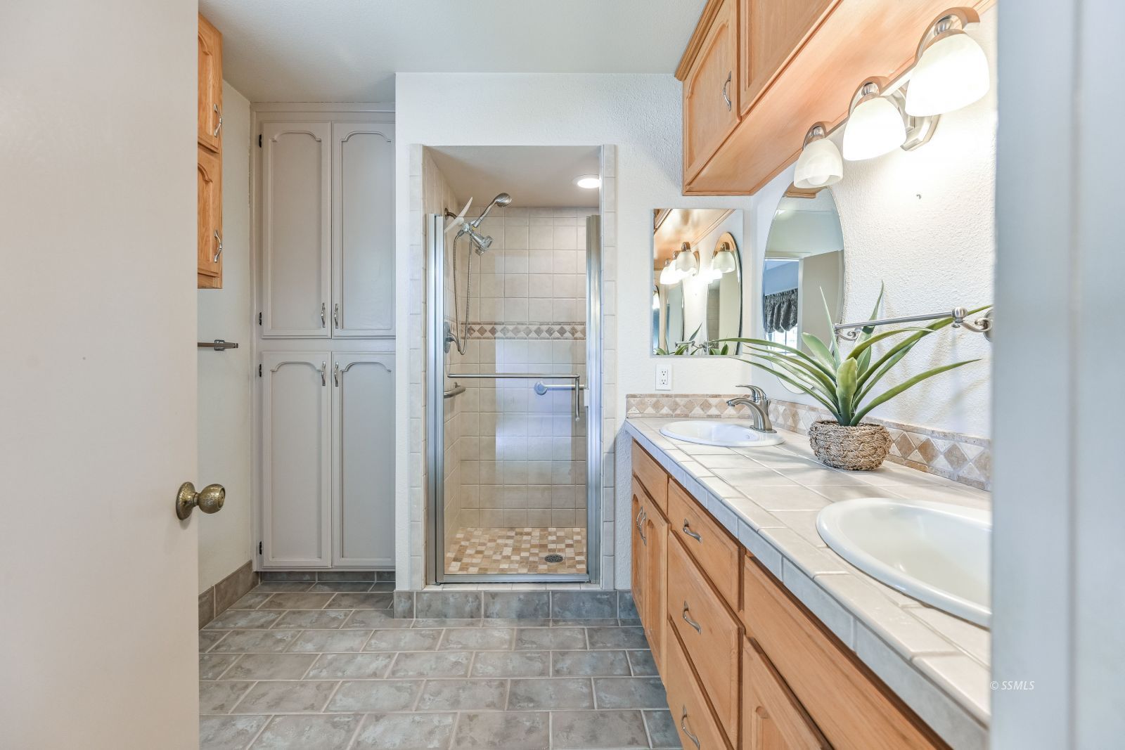 131 Chambers Street Ridgecrest, CA 93555 - Photo 16 of 28 a bathroom with a granite countertop sink a mirror and a shower