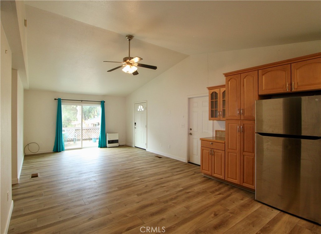 3085 Gardner Road Nice, CA 95464 - Photo 6 of 20 a view of a kitchen with a refrigerator a ceiling fan and wooden floor