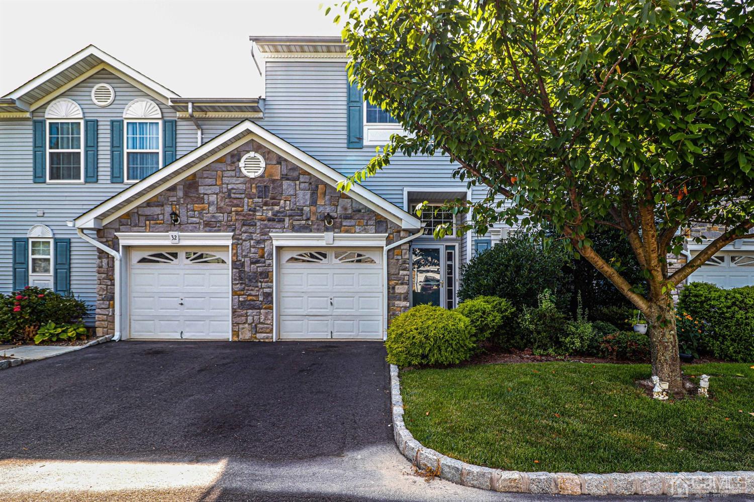 a view of a house with a yard and potted plants
