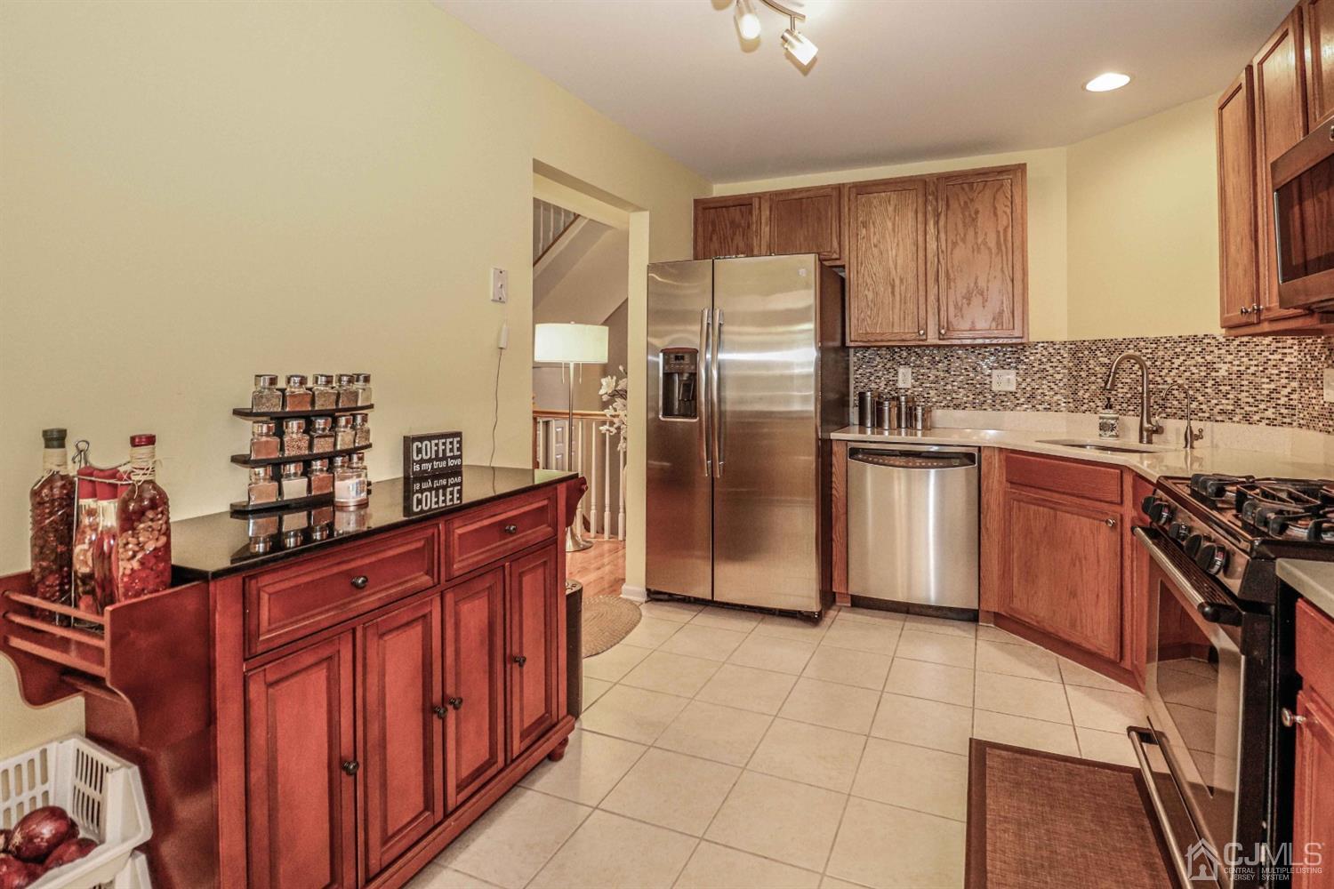 31 Harbor Bay Circle Old Bridge, NJ 08879 - Photo 2 of 36 a kitchen with stainless steel appliances a sink and a refrigerator