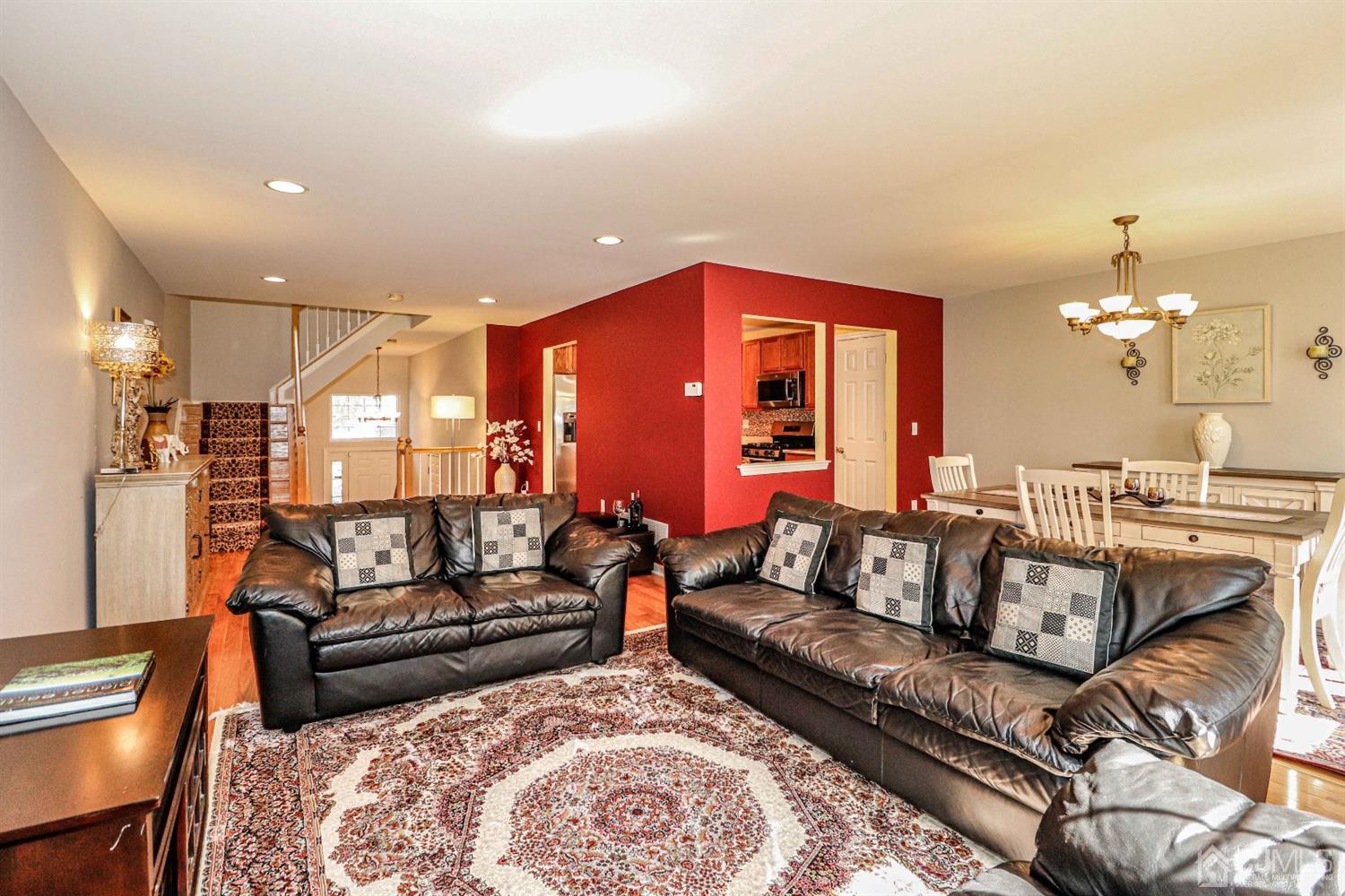 31 Harbor Bay Circle Old Bridge, NJ 08879 - Photo 13 of 36 a living room with furniture a rug and a chandelier