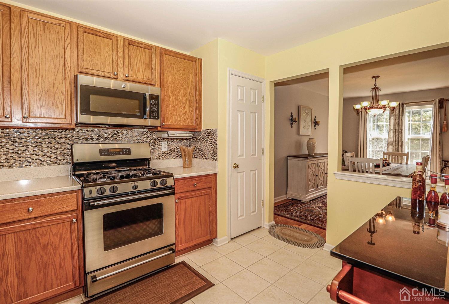 31 Harbor Bay Circle Old Bridge, NJ 08879 - Photo 3 of 36 a kitchen with a stove a sink and a microwave