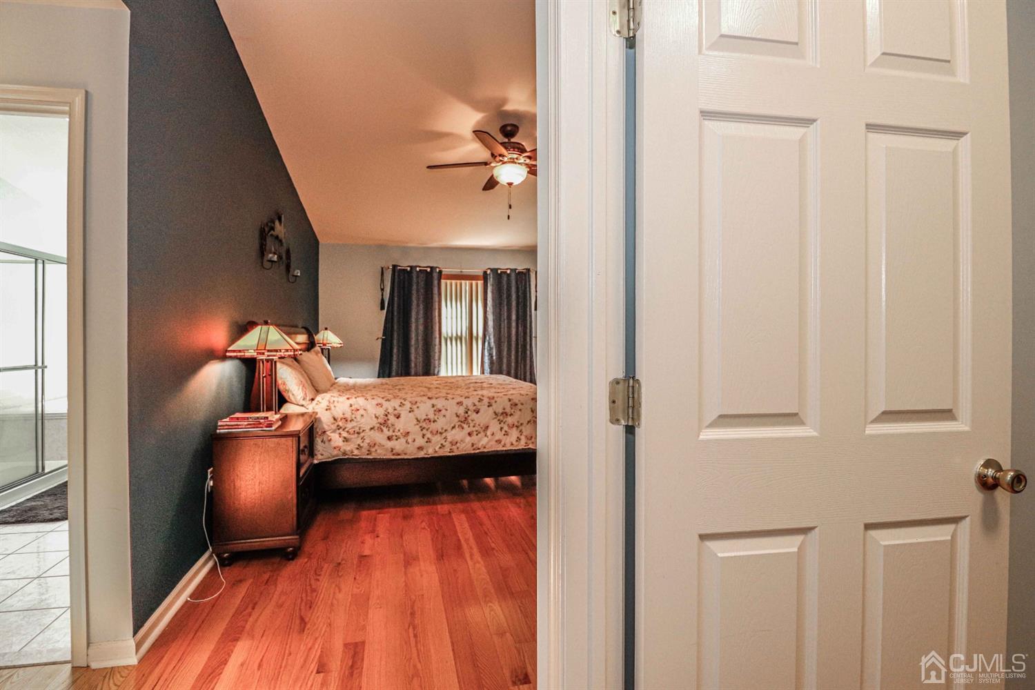 31 Harbor Bay Circle Old Bridge, NJ 08879 - Photo 23 of 36 a bedroom with a bed and wooden floor