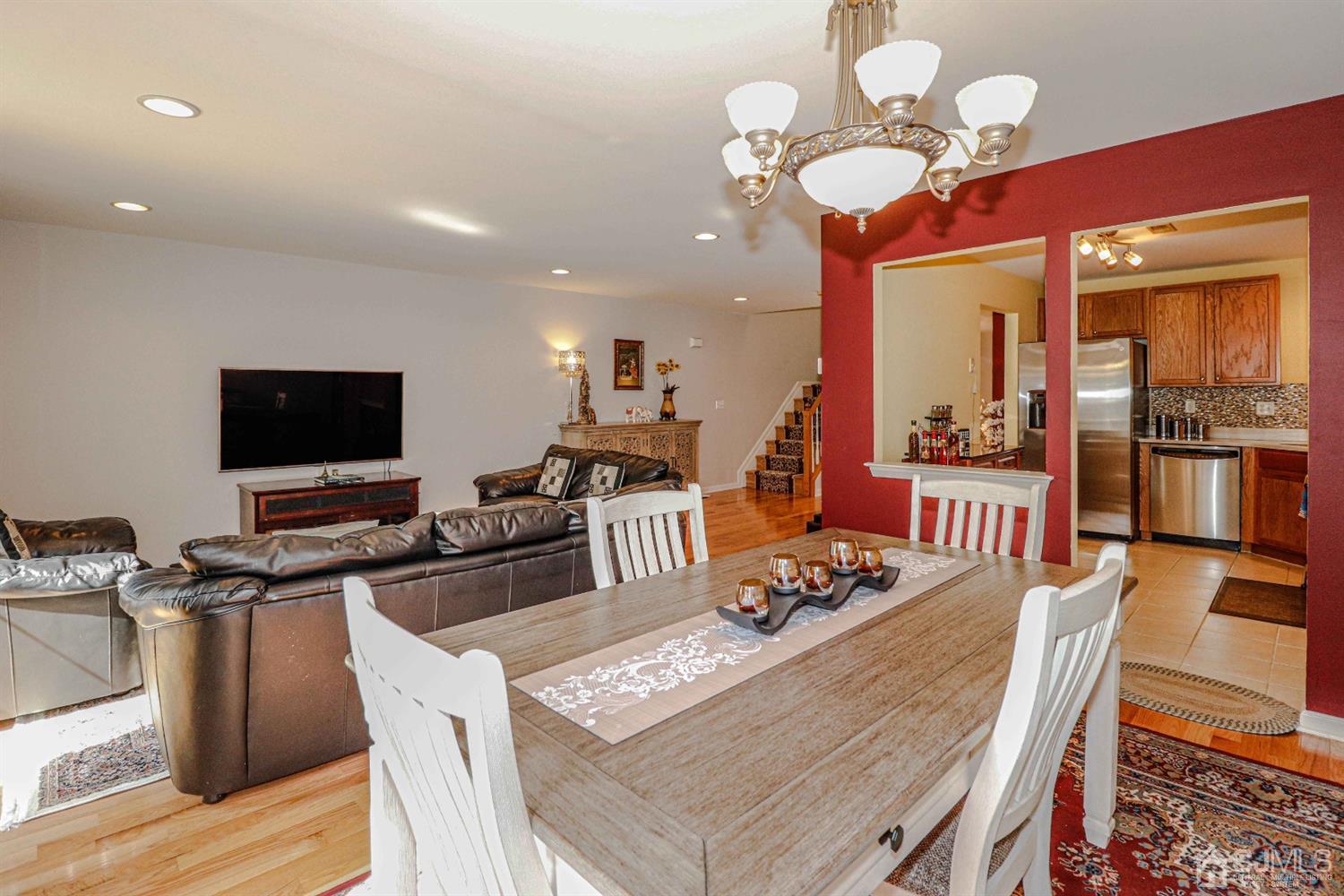 31 Harbor Bay Circle Old Bridge, NJ 08879 - Photo 8 of 36 a view of a dining room with furniture a chandelier and wooden floor