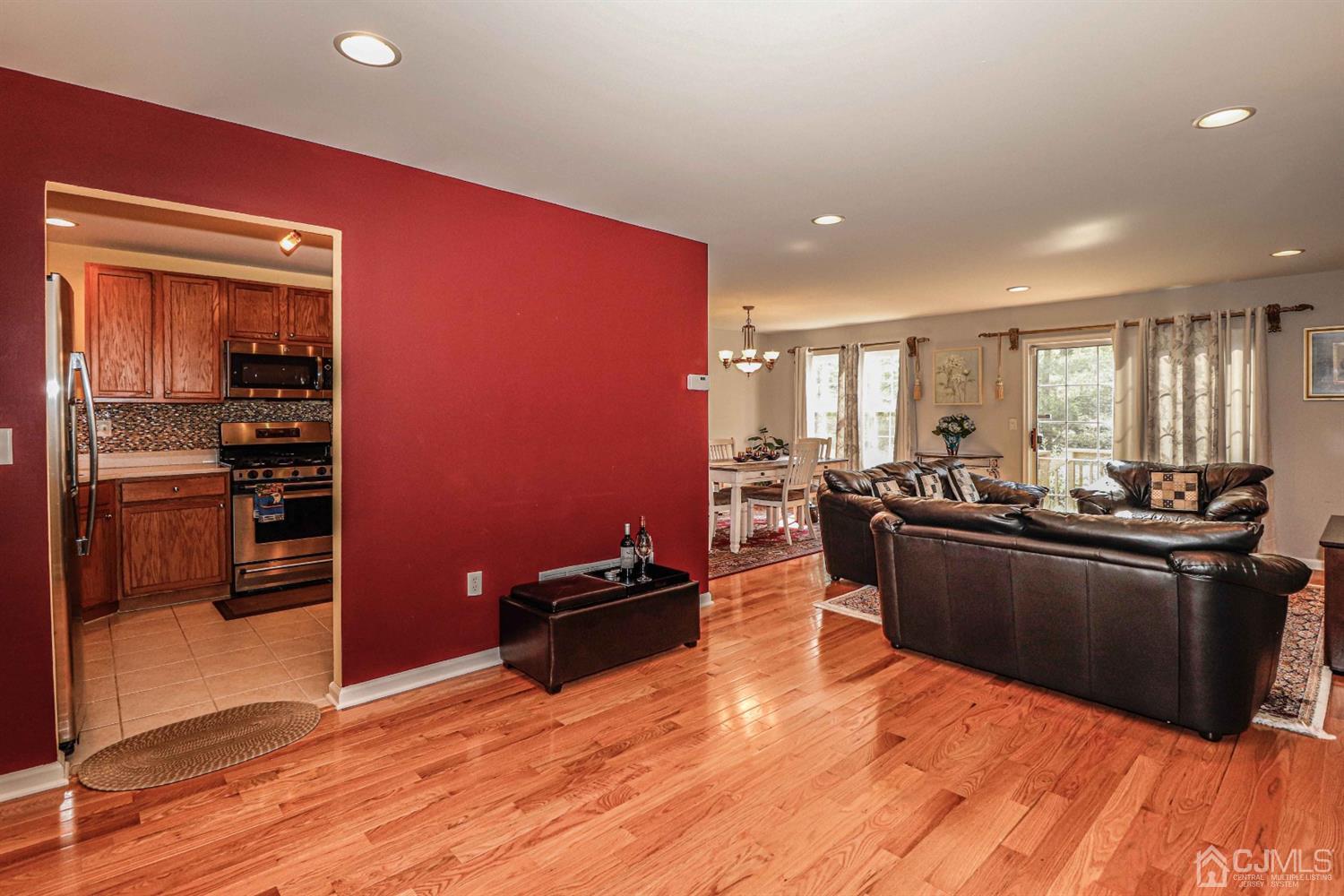31 Harbor Bay Circle Old Bridge, NJ 08879 - Photo 10 of 36 a kitchen with stainless steel appliances wooden floor and living room view