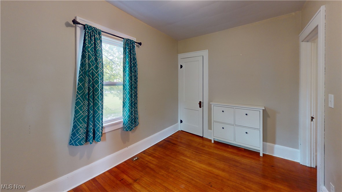 3261 Darrow Road Stow, OH 44224 - Photo 14 of 27 Unfurnished bedroom with wood finished floors and baseboards
