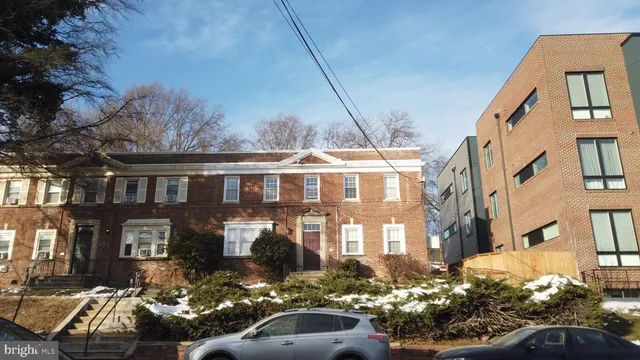 a front view of a residential apartment building with a yard