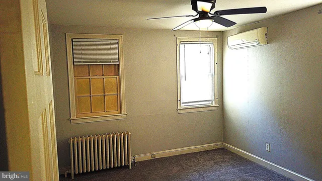 an empty room with windows and closet
