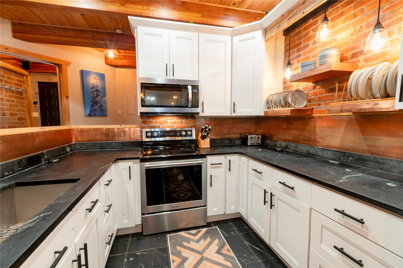 2739 Burgess Creek Road, Unit 10 Steamboat Springs, CO 80487 - Photo 13 of 46 a kitchen with stainless steel appliances granite countertop a stove a sink and a microwave