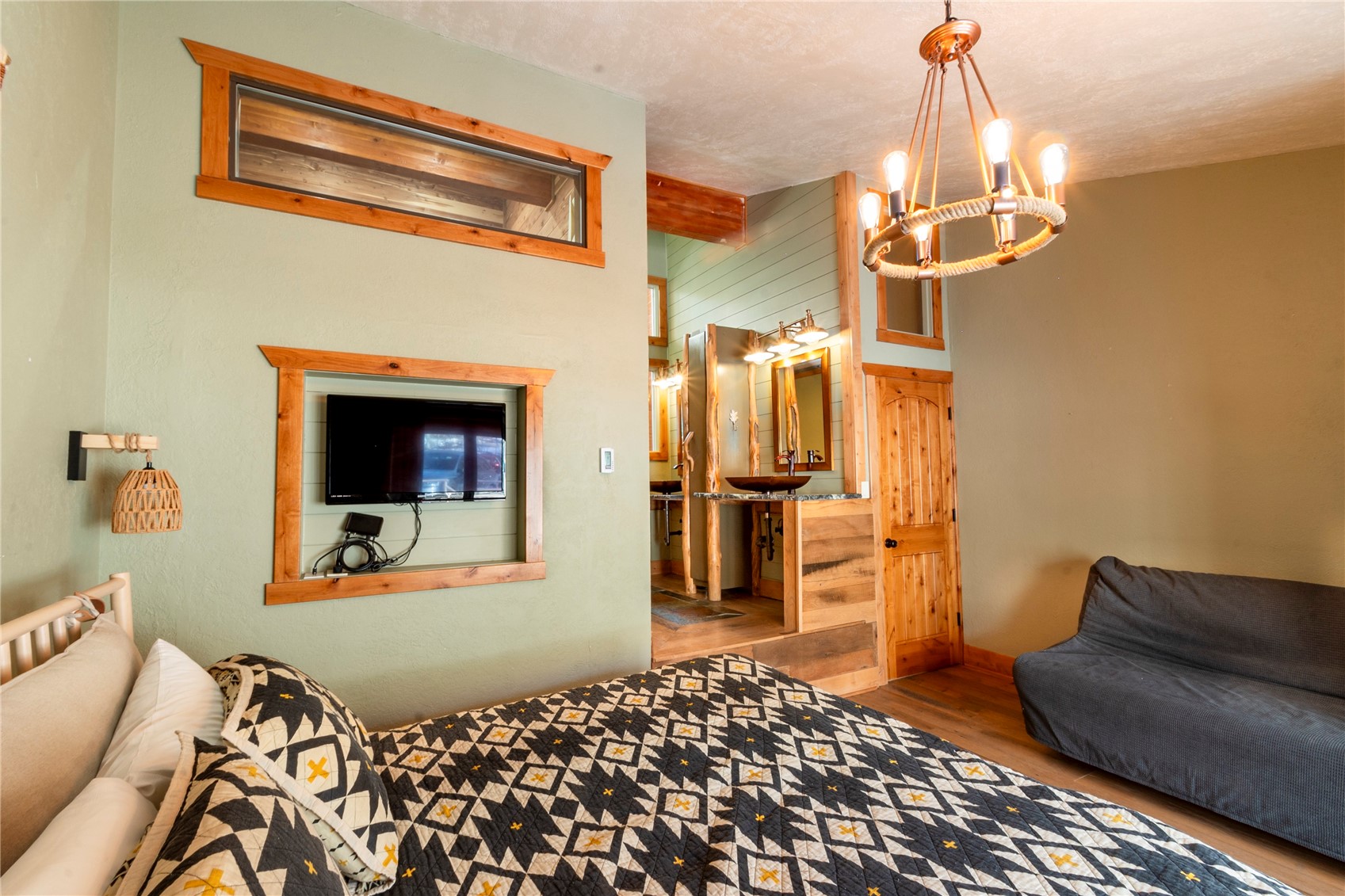 2739 Burgess Creek Road, Unit 10 Steamboat Springs, CO 80487 - Photo 20 of 46 a bedroom with furniture and a chandelier