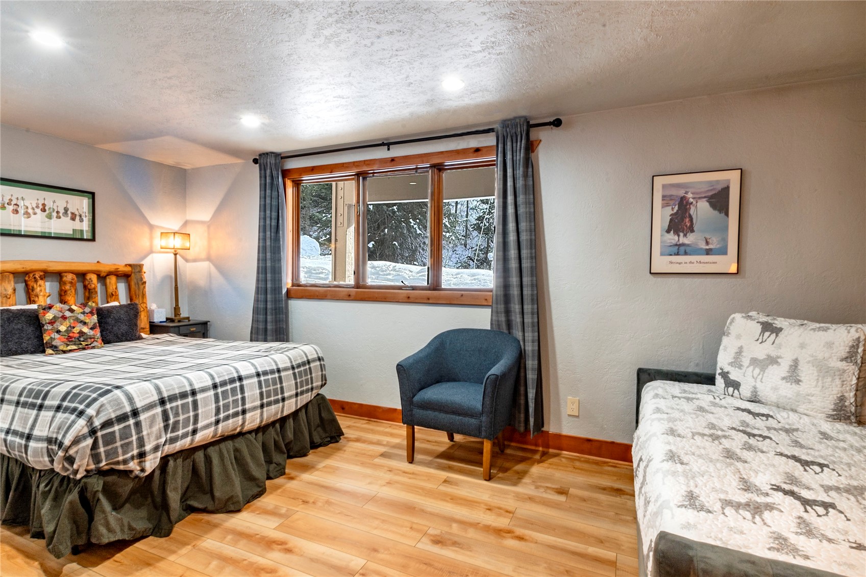 2739 Burgess Creek Road, Unit 10 Steamboat Springs, CO 80487 - Photo 26 of 46 a bedroom with a bed and wooden floor