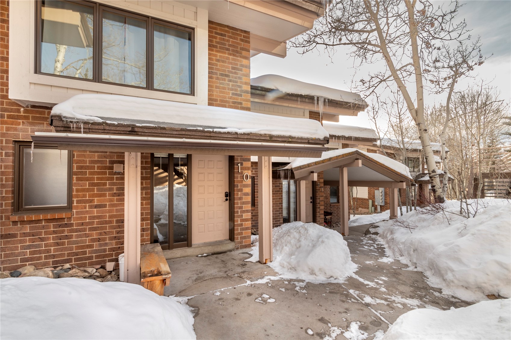 2739 Burgess Creek Road, Unit 10 Steamboat Springs, CO 80487 - Photo 34 of 46 a view of a white house with large windows