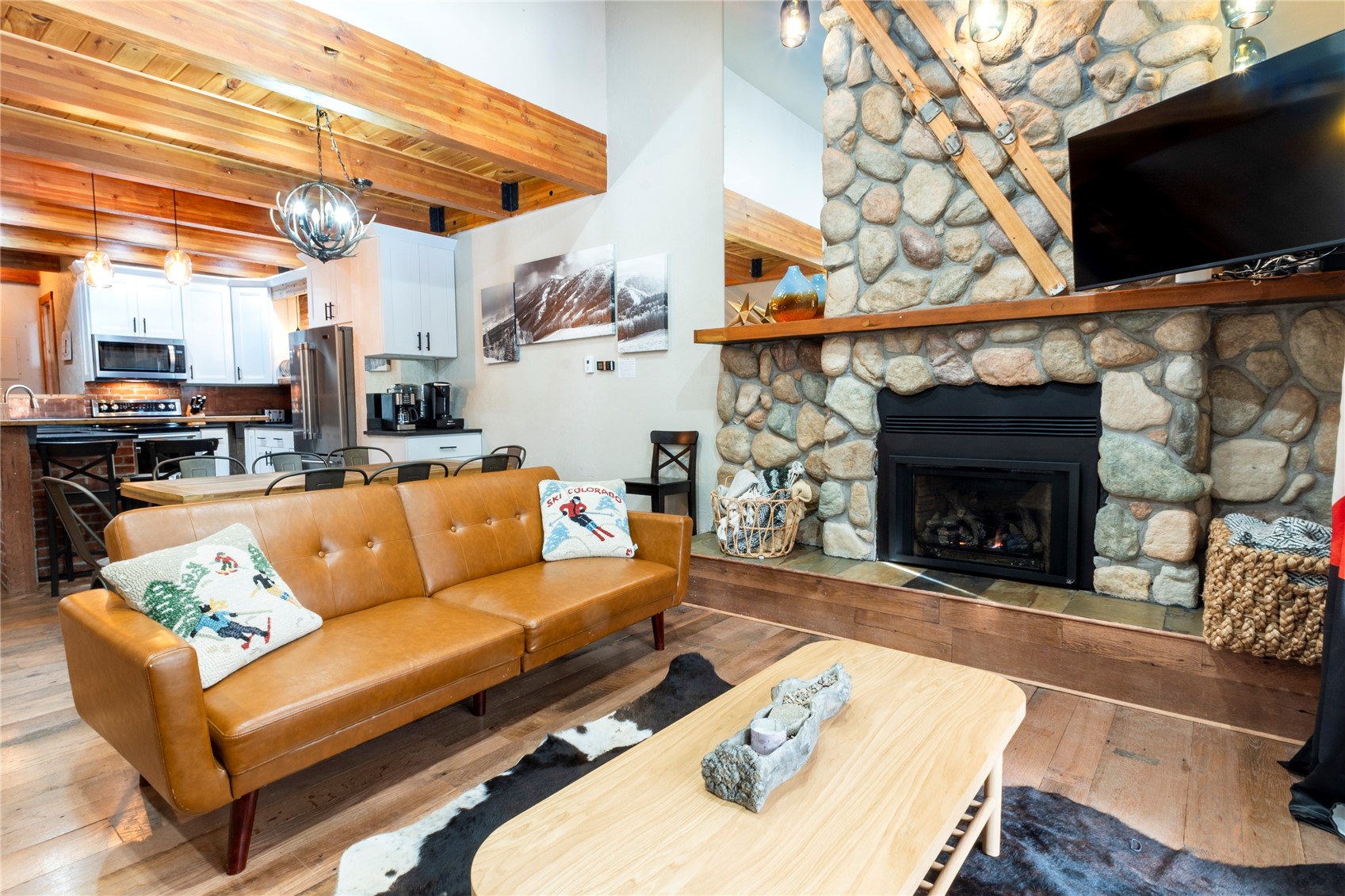 2739 Burgess Creek Road, Unit 10 Steamboat Springs, CO 80487 - Photo 5 of 46 a living room with furniture a flat screen tv and a fireplace