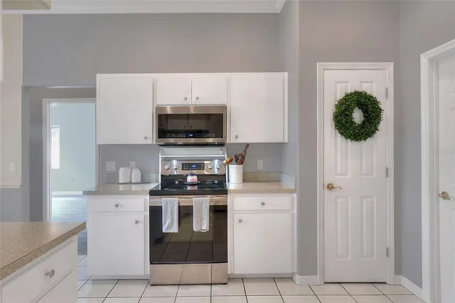 a kitchen with stainless steel appliances granite countertop a sink and a refrigerator
