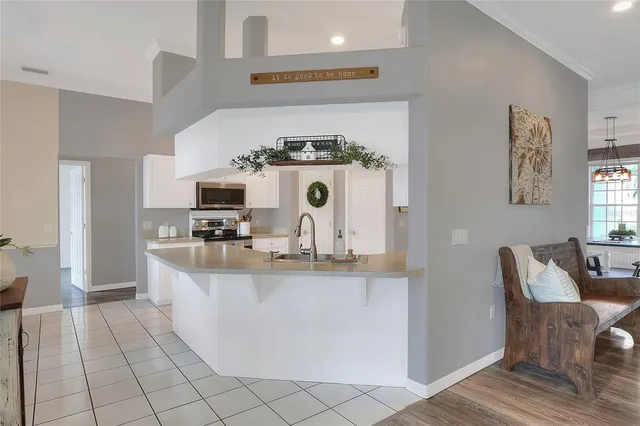 a dining room with furniture a chandelier and wooden floor