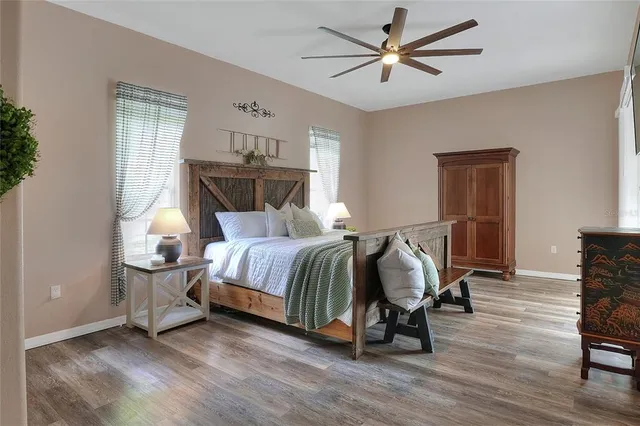 a bedroom with a bed and wooden floor