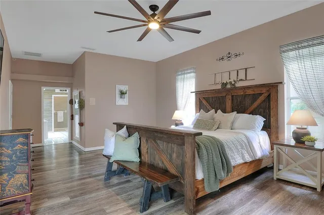 a spacious bathroom with a double vanity sink a mirror and a shower