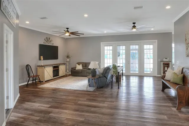 a view of a a dining room with furniture window and wooden floor