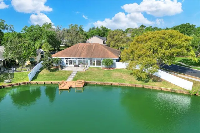 an aerial view of a house with garden space and lake view