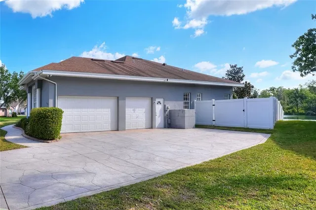 a view of a house with a swimming pool and a yard