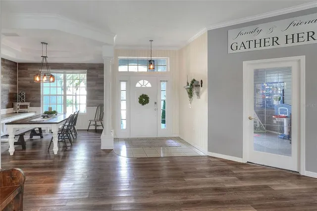 a living room with furniture a ceiling fan and a flat screen tv