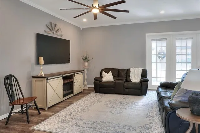 a living room with furniture and wooden floor