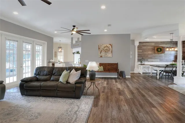 a living room with furniture and wooden floor