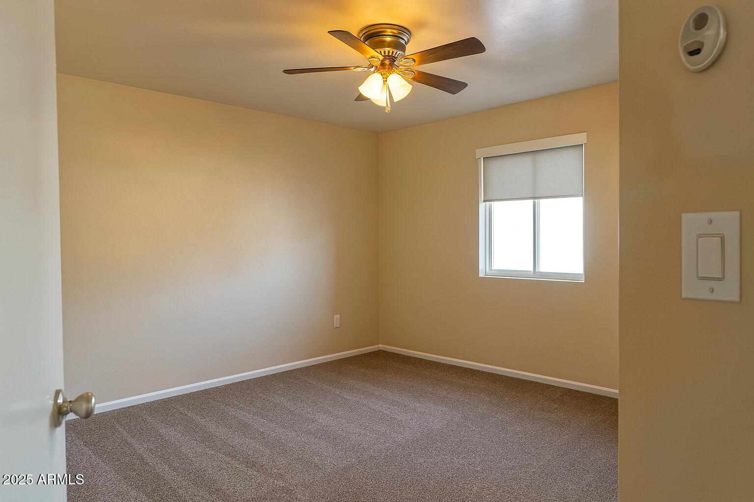 1708 West Cortez Circle Chandler, AZ 85224 - Photo 11 of 22 an empty room with a window and a fan