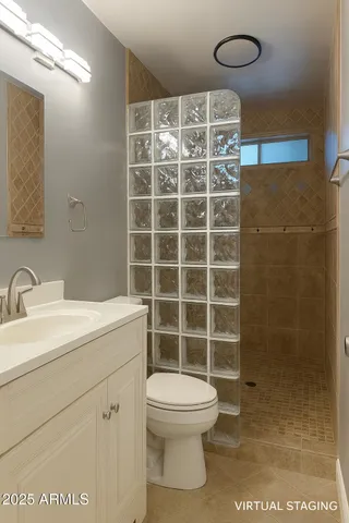a bathroom with a toilet a sink and a shower
