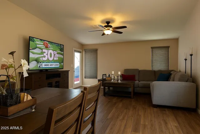 a living room with furniture and a wooden floor