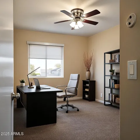 a view of a workspace with furniture and a window