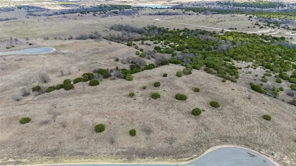 a view of dirt field with beach