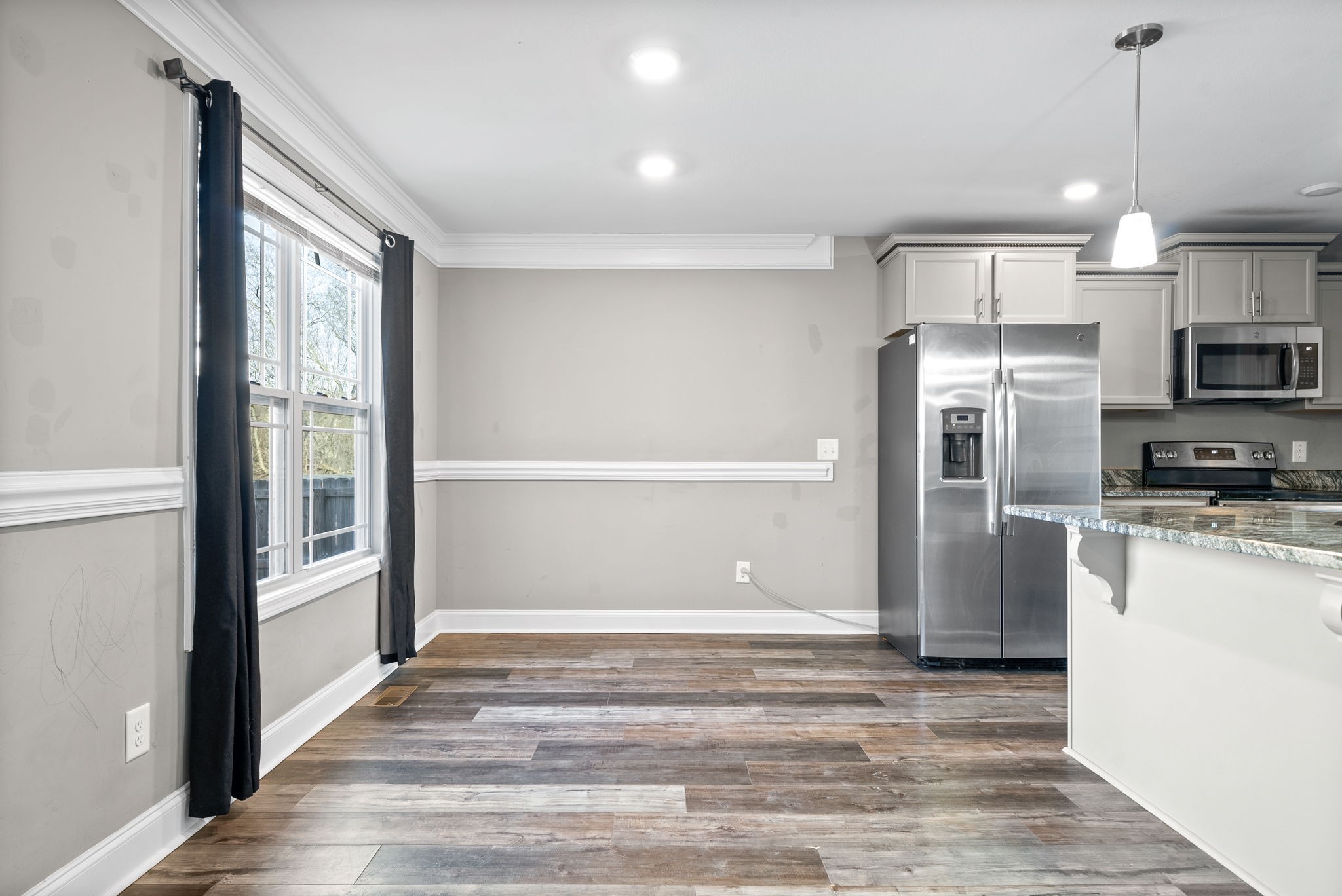 1868 Rains Road Clarksville, TN 37042 - Photo 13 of 39 a view of a kitchen with a refrigerator a stove top oven and kitchen space