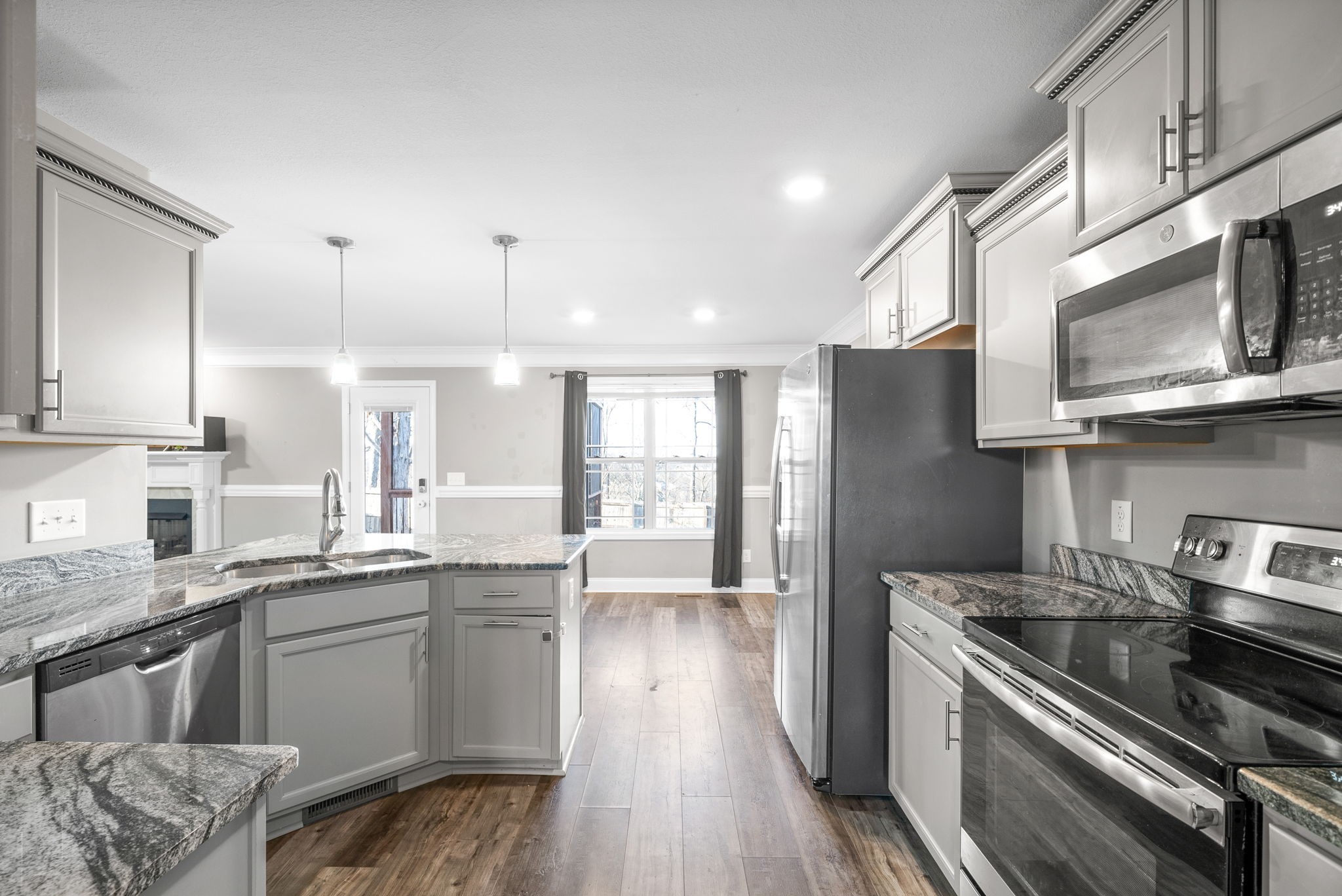 1868 Rains Road Clarksville, TN 37042 - Photo 16 of 39 a kitchen with stainless steel appliances granite countertop a stove a sink and a refrigerator
