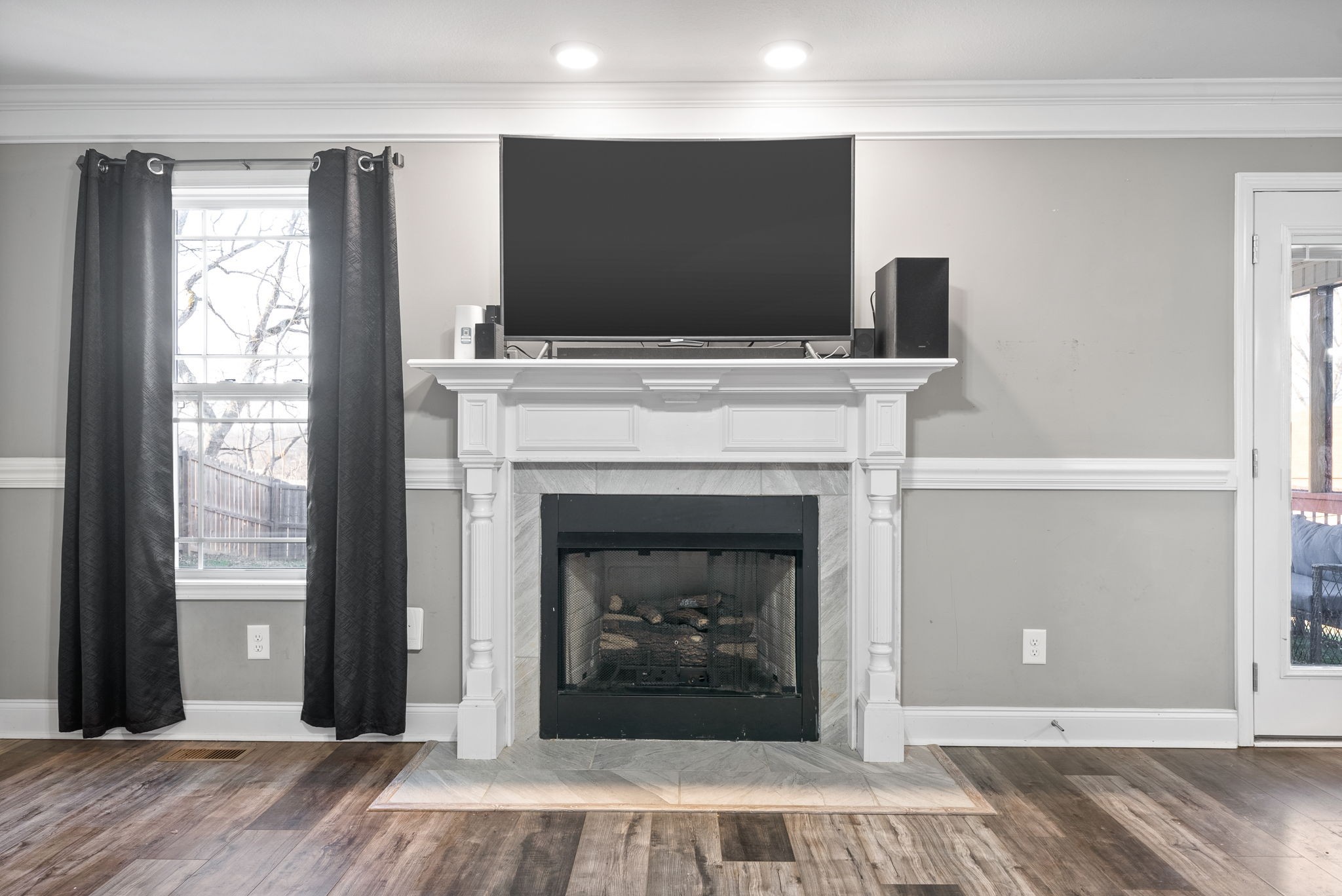 1868 Rains Road Clarksville, TN 37042 - Photo 8 of 39 a living room with a fireplace and a flat screen tv