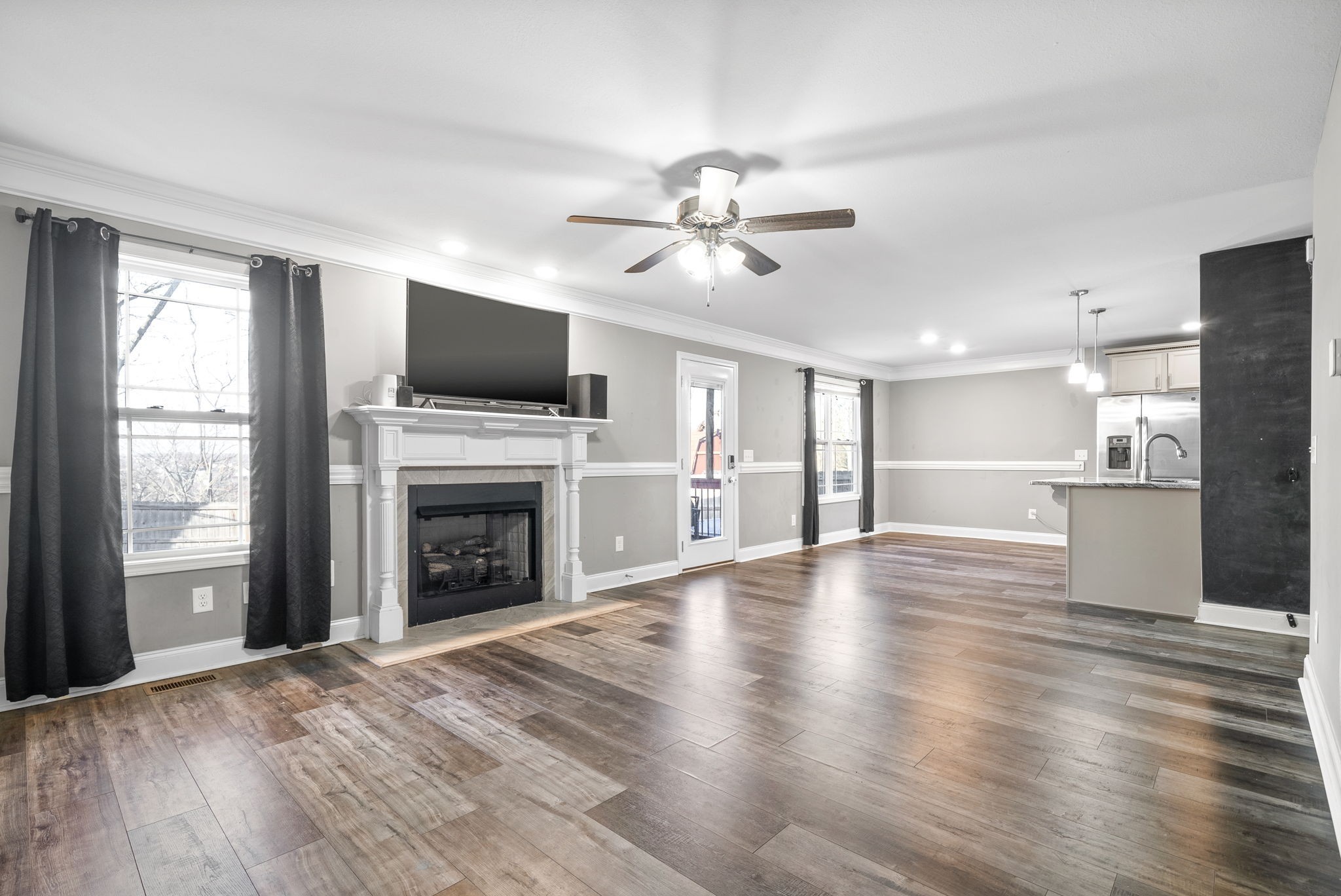 1868 Rains Road Clarksville, TN 37042 - Photo 10 of 39 a view of a livingroom with a fireplace a ceiling fan and windows