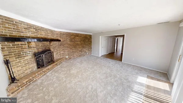 a view of empty room with fireplace