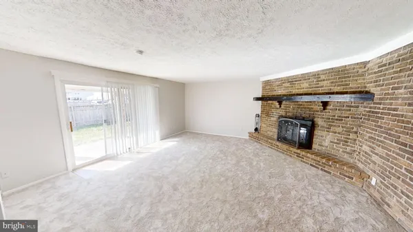 a view of empty room with a fireplace