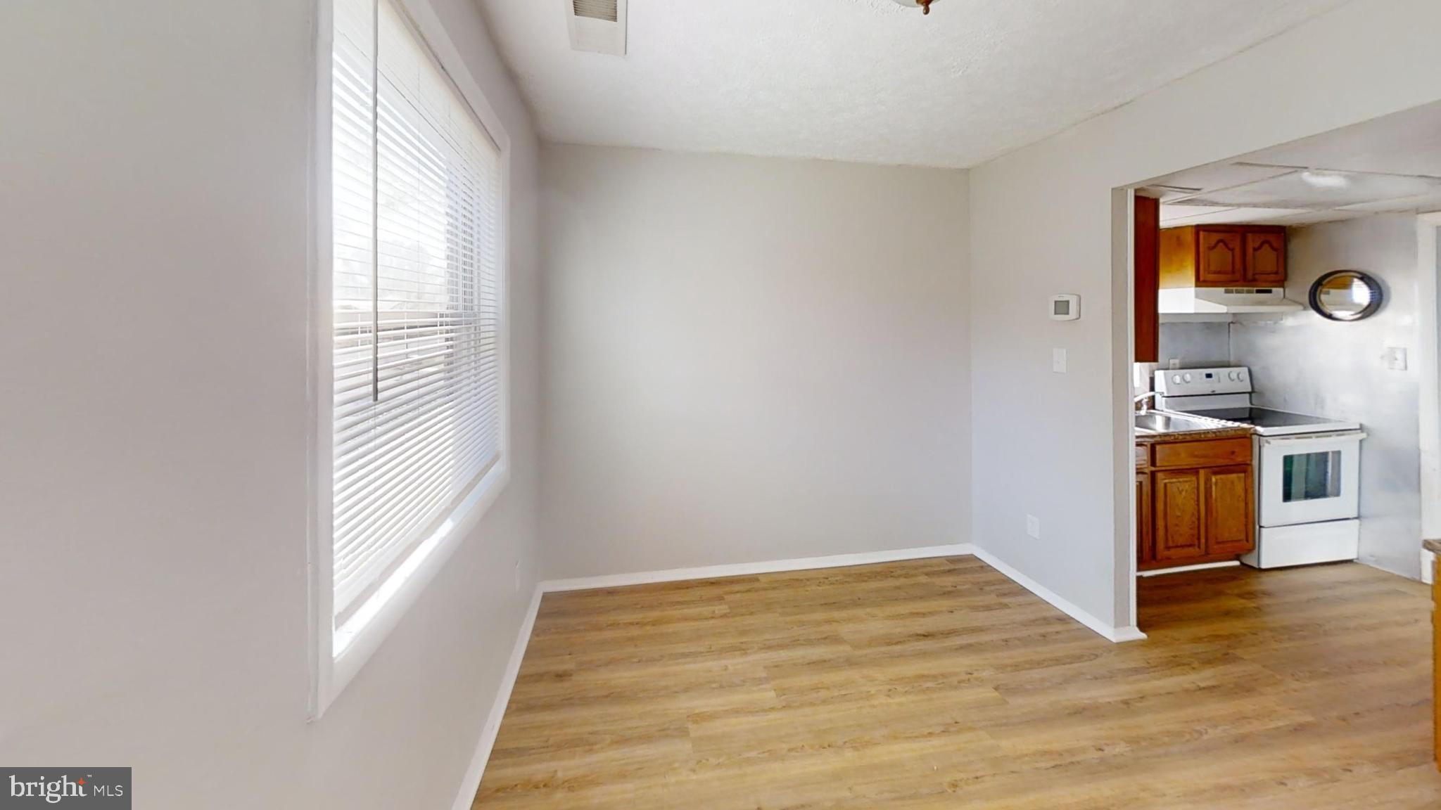150 Dunlap Road Pasadena, MD 21122 - Photo 4 of 24 a view of a kitchen cabinets and wooden floor