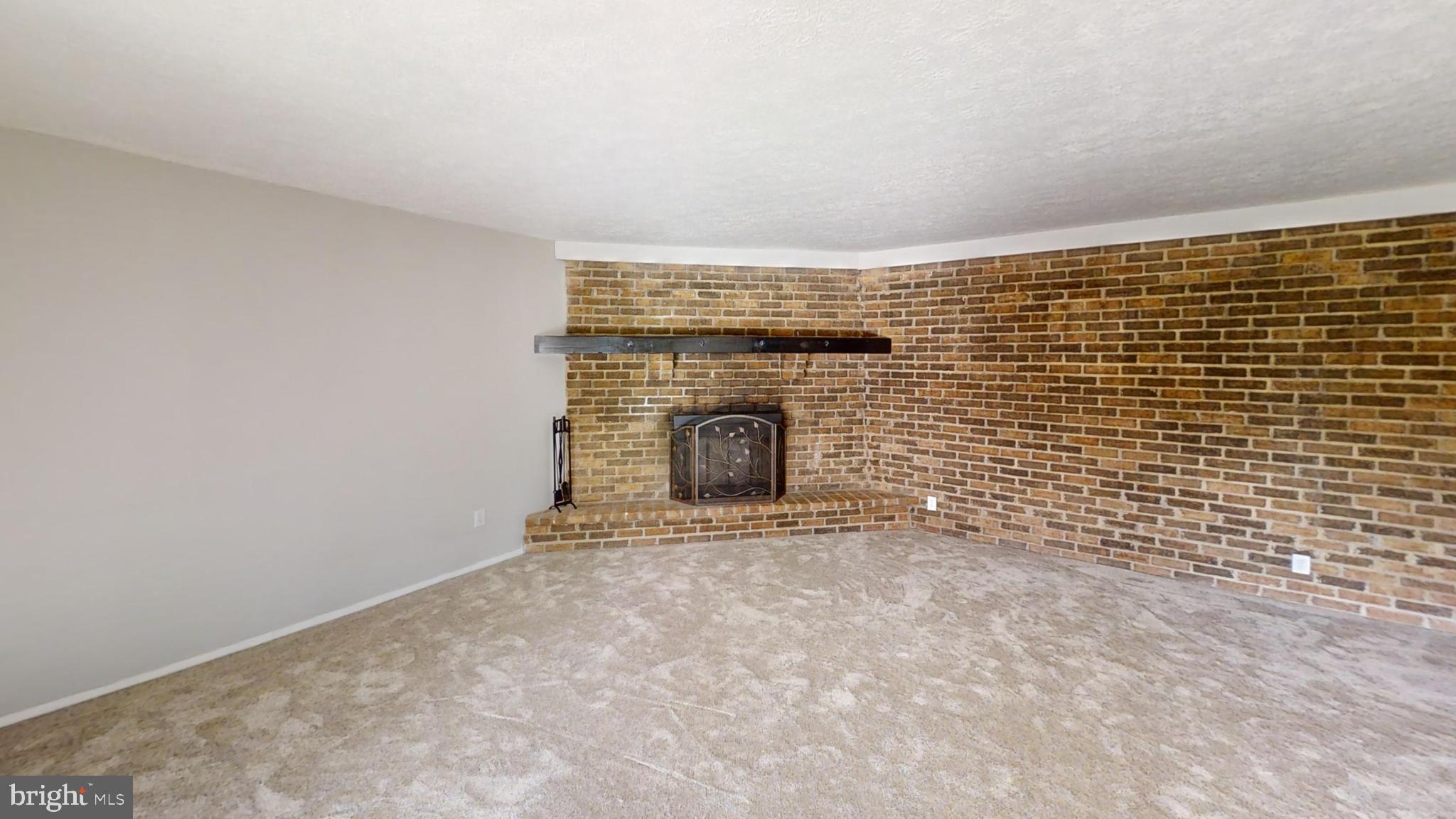 150 Dunlap Road Pasadena, MD 21122 - Photo 9 of 24 a view of empty room with fireplace