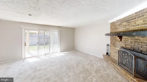 a view of an empty room with a fireplace