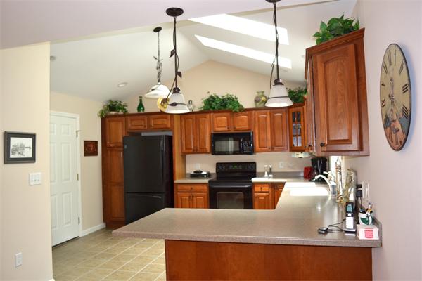 27 Benjaman Drive, Unit 27 Rochester, MA 02770 - Photo 8 of 22 a kitchen with refrigerator a sink and cabinets