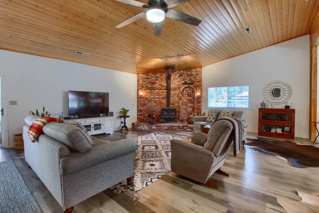 50537 Cedar Valley Drive Oakhurst, CA 93644 - Photo 11 of 59 a living room with furniture and a flat screen tv
