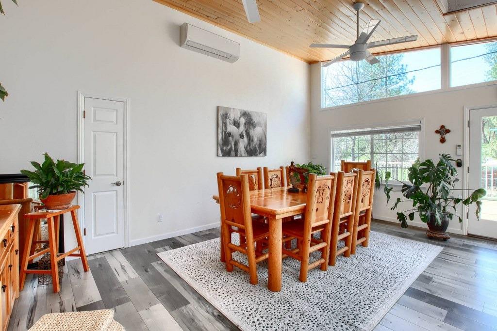 50537 Cedar Valley Drive Oakhurst, CA 93644 - Photo 18 of 59 a dining room with furniture potted plants and wooden floor
