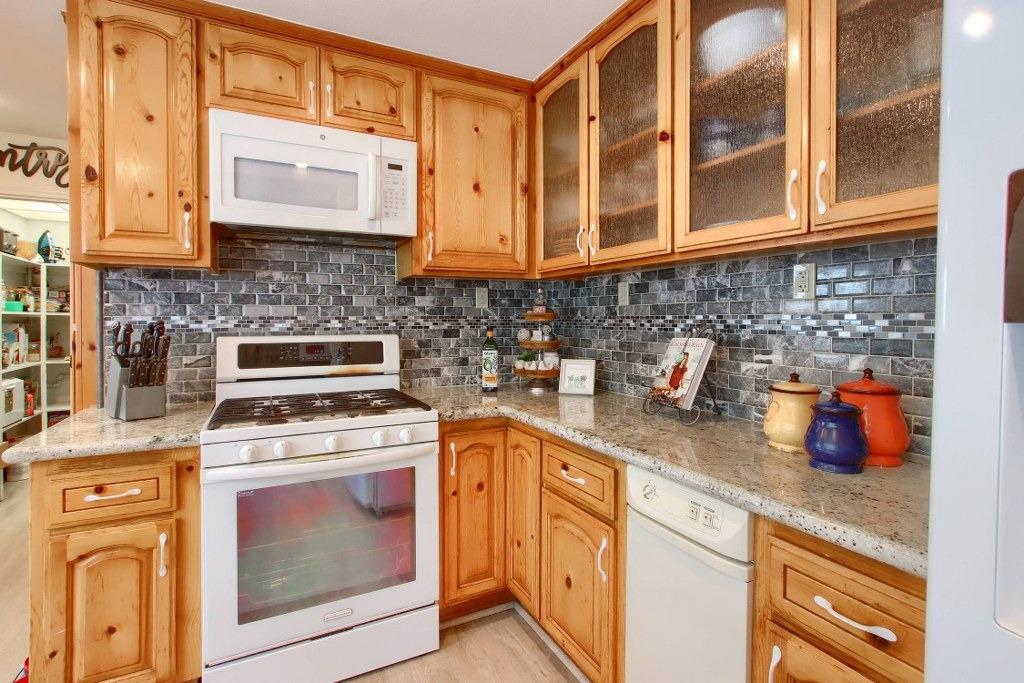 50537 Cedar Valley Drive Oakhurst, CA 93644 - Photo 22 of 59 a kitchen with stainless steel appliances granite countertop cabinets and a stove top oven