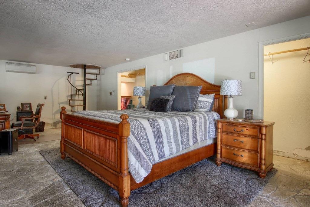 50537 Cedar Valley Drive Oakhurst, CA 93644 - Photo 28 of 59 a bed room with a bed and a lamp