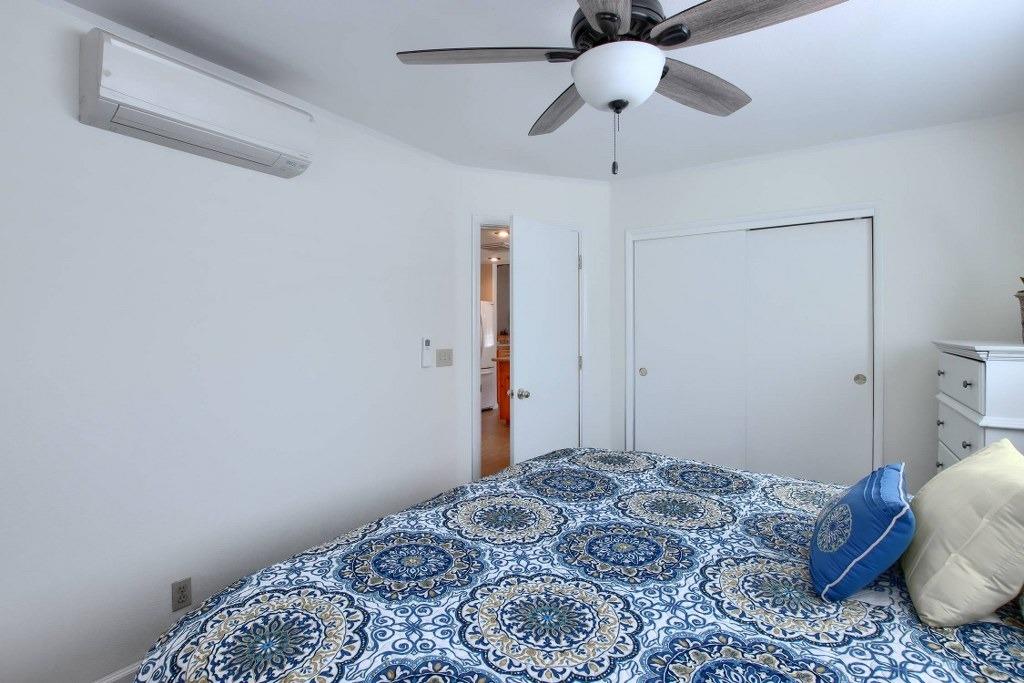 50537 Cedar Valley Drive Oakhurst, CA 93644 - Photo 32 of 59 a bedroom with a bed and a chandelier